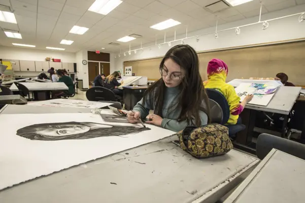 Student drawing a self-portrait.