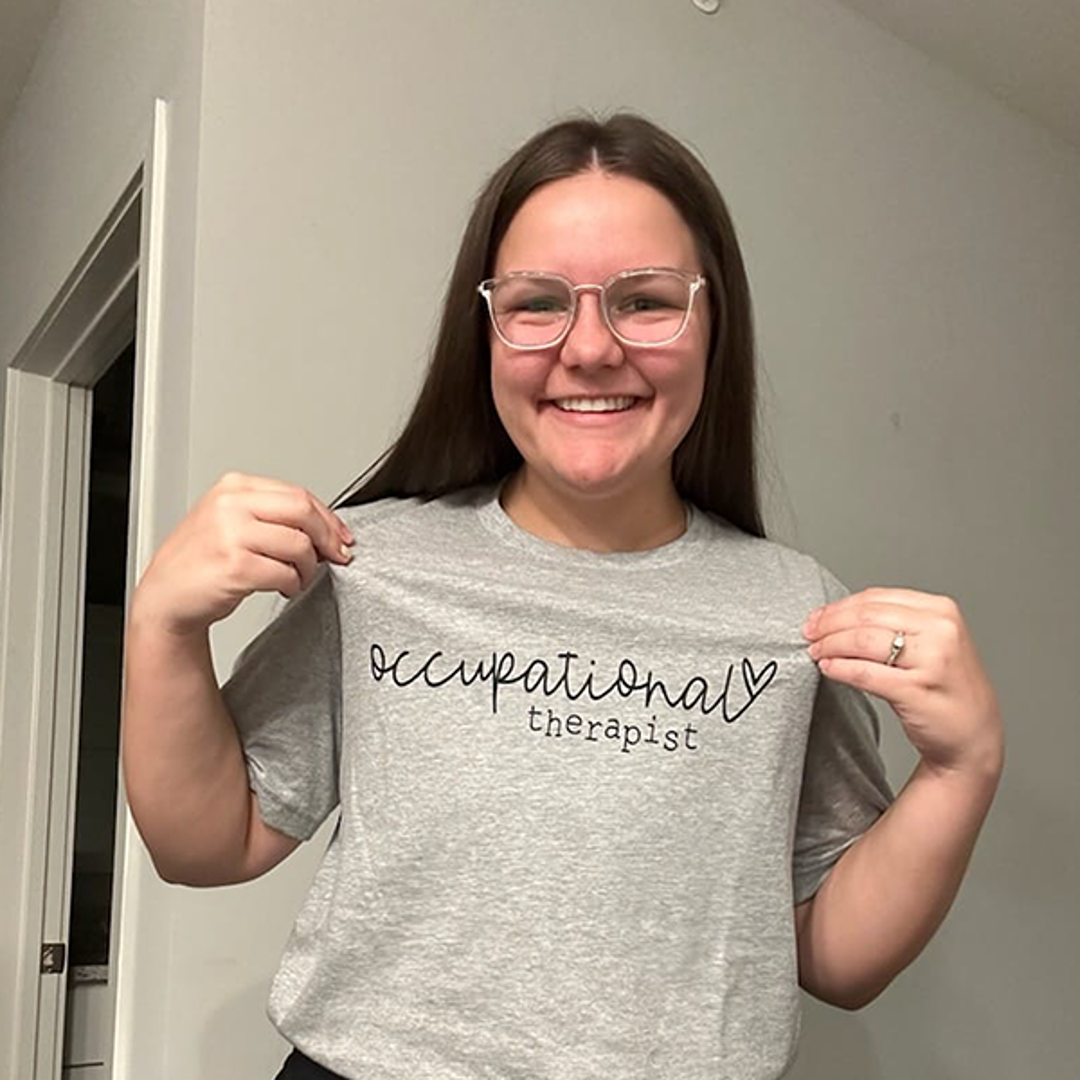 Student wearing a T-shirt that says "occupational therapist"