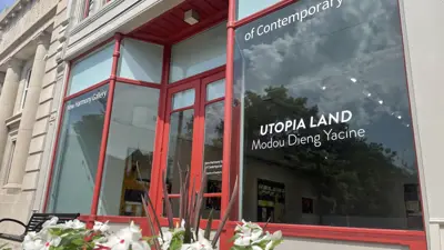 An exterior view of the New Harmony art gallery, with the current exhibit name on the window
