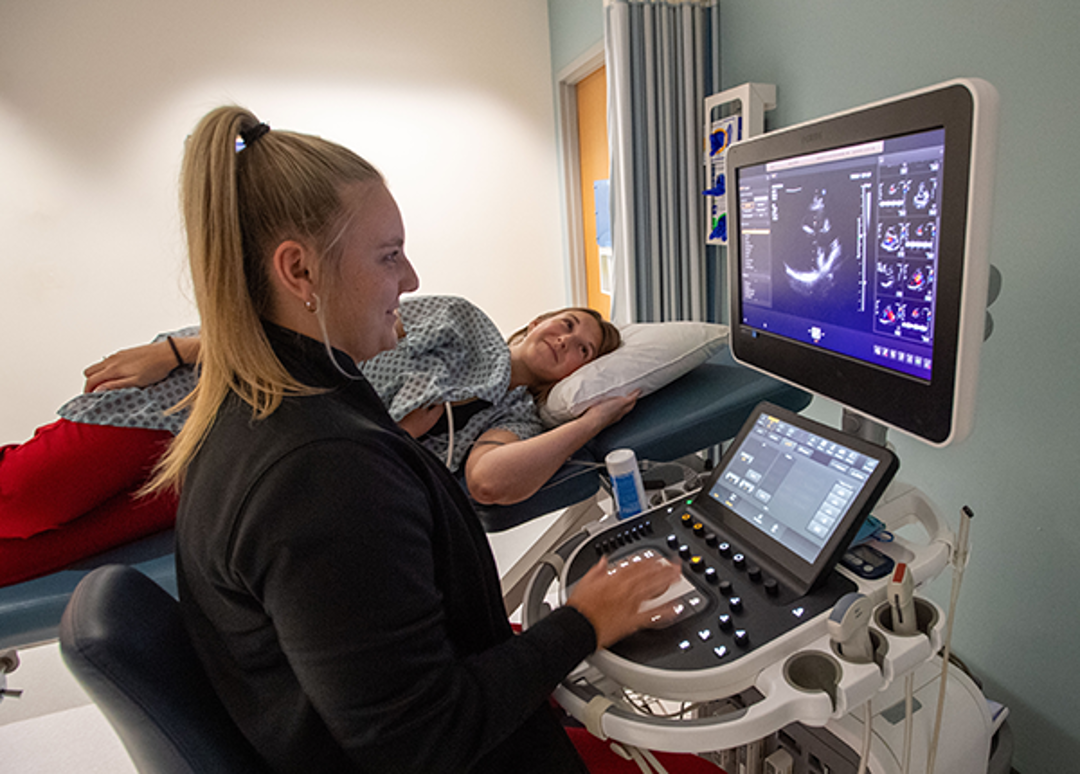 Student scanning another student in sonography lab
