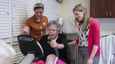 AIT student with nursing home staff and resident