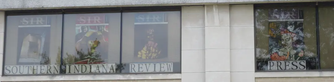 Posters of SIR covers hang in the windows of the Orr Center, seen from the exterior
