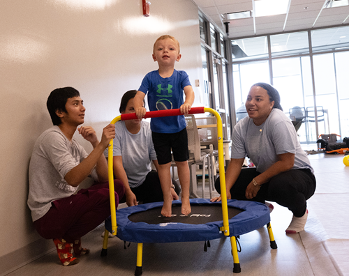 Students working with child in OT room