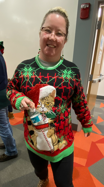 Photo of woman wearing a cat ugly sweater 