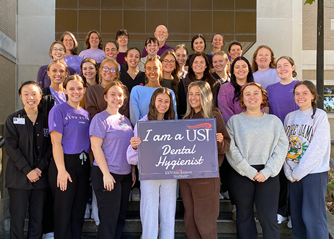 Dental Hygiene Faculty and Students holding sign