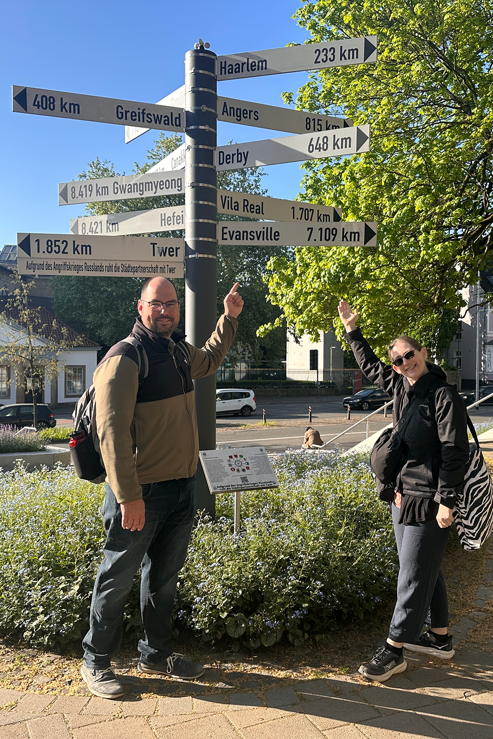 Two faculty members by directional sign in Germany