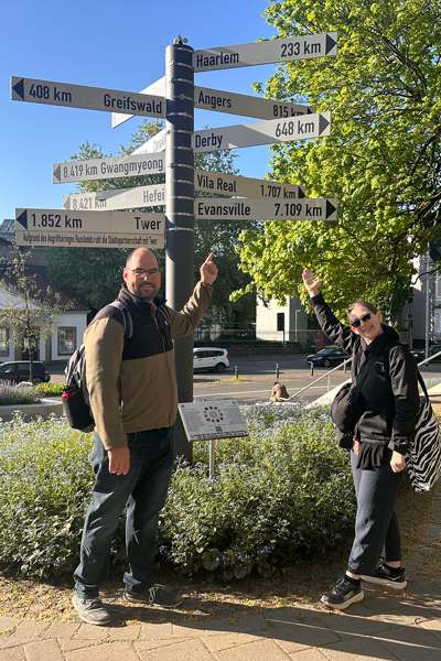 Two faculty members by directional sign in Germany