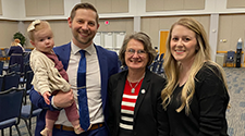 Photo of Sigma speaker with faculty, wife and child