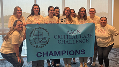 Nursing students holding a banner at the competition