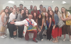 Students pose with photo of a doctor dressed as a clown