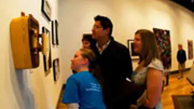 Honors students examining a sculpture from 2009 Senior Seminar Exhibition