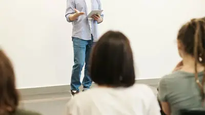 Financial Success Center staff member gives a presentation to a class