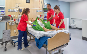 nursing students using a lift in simulation center