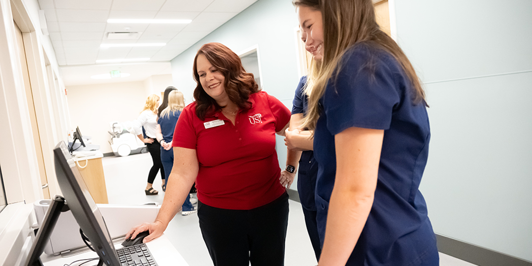 USI faculty reviews imaging on a computer with a student
