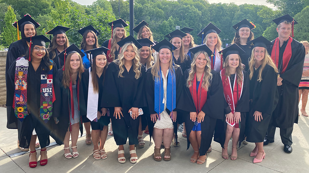 large group of radiology students in caps and gowns at graduation