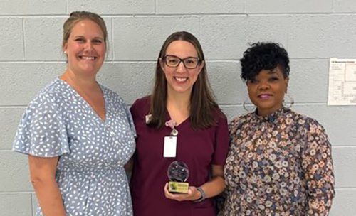 Photo of AHEC team presenting trophy to outstanding preceptor