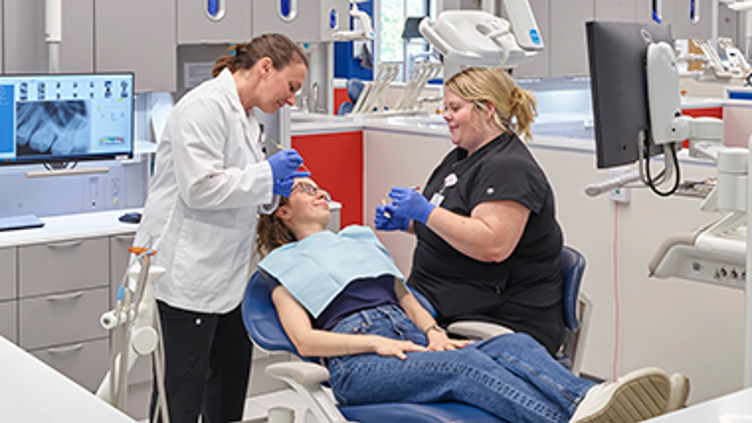 Photo of faculty and students working in dental clinic