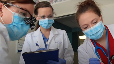 Students in dental clinic wearing masks
