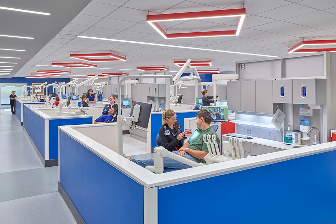 Photo of students working with patients in dental clinic
