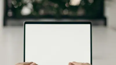 Hands typing on a laptop