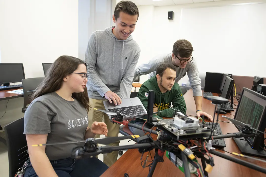 A group of students work on a computer science project.