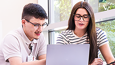 Two students looking at laptop