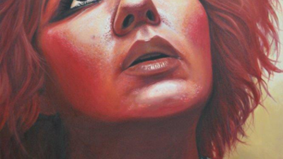 "The Saint", painting. Woman wearing checked shirt looking upwards. Light from above illuminates her face