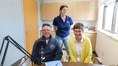 Podcast team in recording studio with a guest