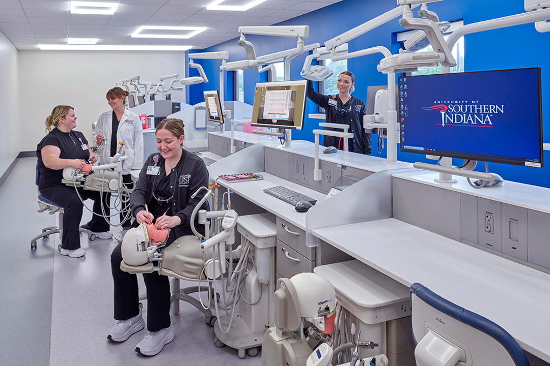 Photo of students working in dental assisting lab