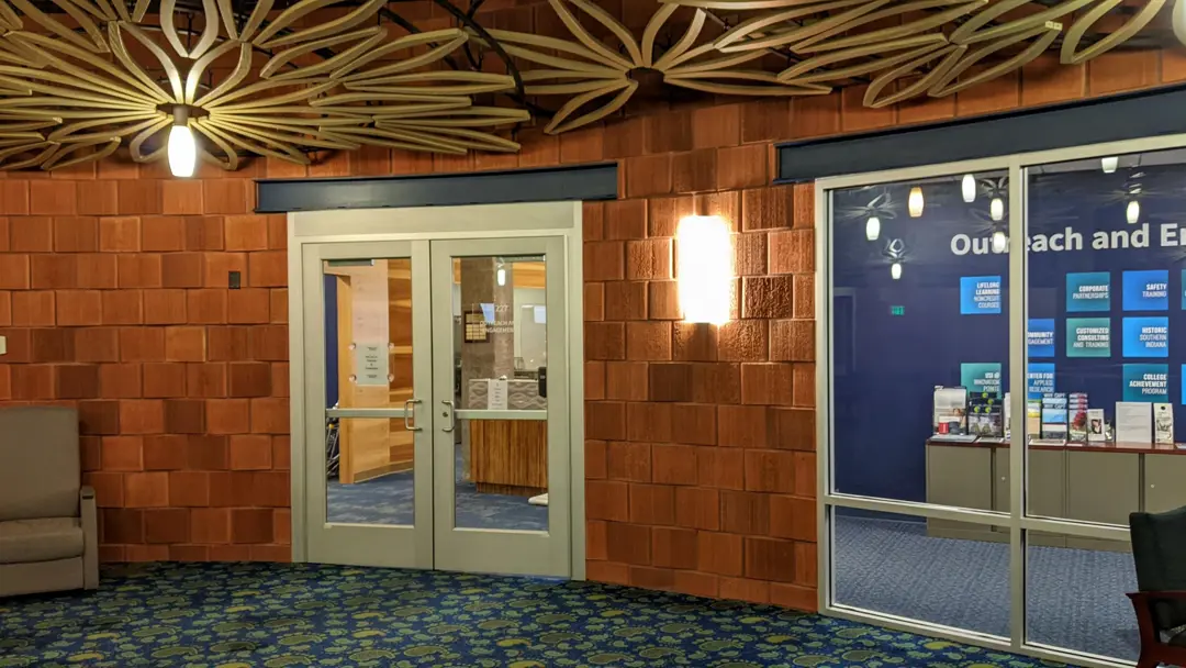 Photo of the doors into the Outreach and Engagement offices from the Fireside Lounge in University Center East