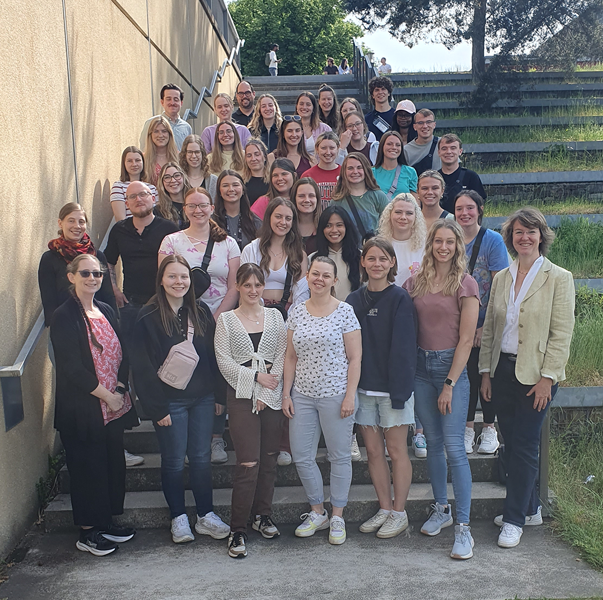 USI and Germany students pose for photo on steps