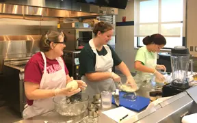 Students making dough in the quantity food kitchen
