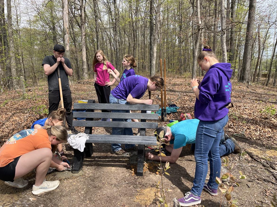 A Scouting Troop helps a 2025 Eagle Scout install some benches on Bent Twig Trail. 
