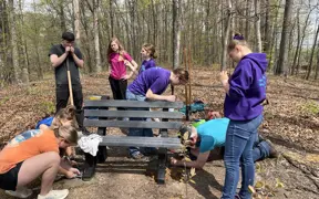 A Scouting Troop helps a 2025 Eagle Scout install some benches on Bent Twig Trail. 