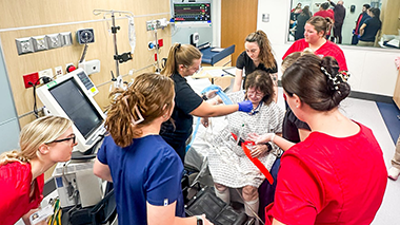 Students working with standardized patient in simulation center
