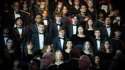 A group of Choir members in formal attire at a performance