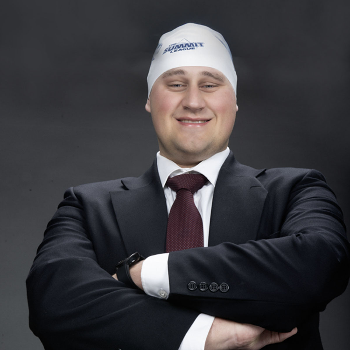 A member of the homecoming court wears one of the swim hats left in the studio for one of his homecoming photos.