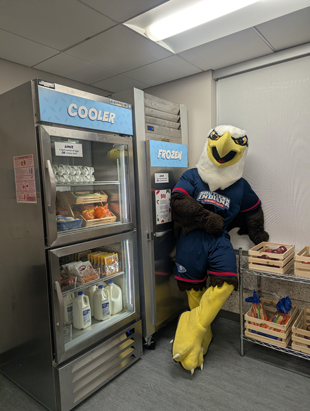 Archie standing by the cooler and freezer inside the pantry