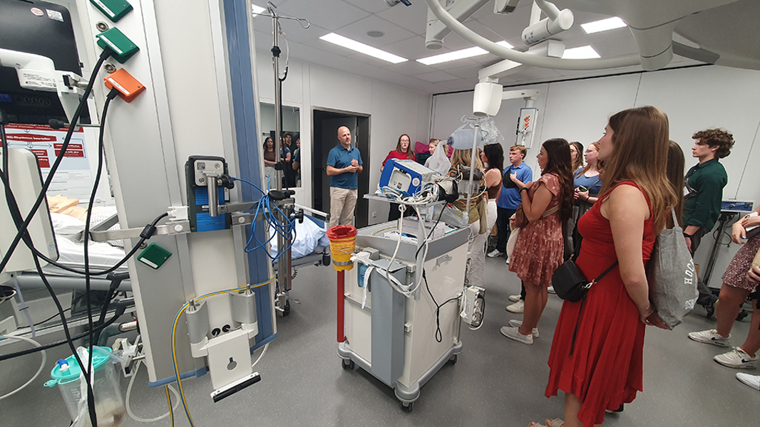 Students listen to guide during hospital tour