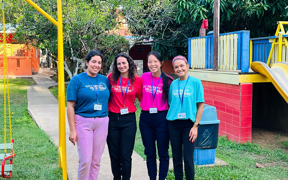 Four OT students pose for photo on playground