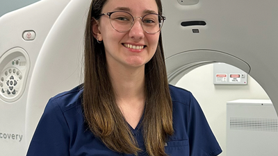 Photo of Grace Range in front of CT scanner