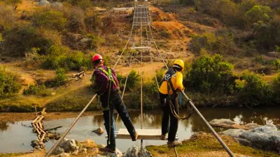 Civil engineering students working on a suspension bridge