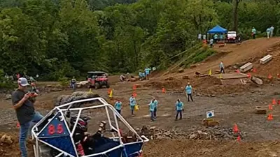 Society of Automotive Engineers members test drive their Baja Car on rough terrain
