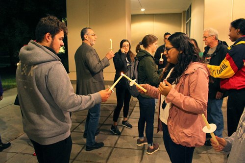 Students participate in a candlelight procession honoring the victims of mass shootings