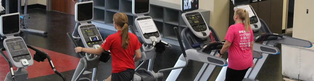 Students walking on treadmills in the cardio area of the Recreation, Fitness and Wellness Center