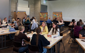 Students in group discussion in a large classroom in Germany