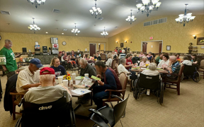Students playing bingo with nursing home residents