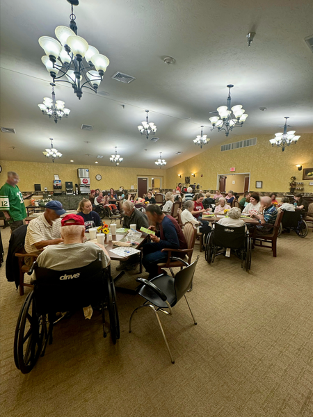 Students playing bingo with nursing home residents