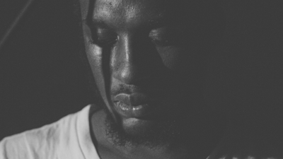 Moody black and white portrait of a man looking away from the camera