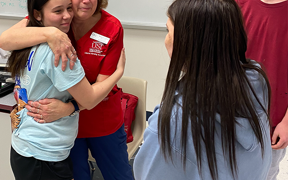 Photo of Susan Seibert hugging the teen she helped